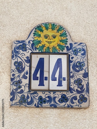 Hand painted ceramic tiles that say number 44