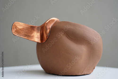 Abstract clay sculpture with hammered copper handle accent