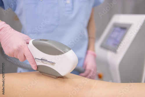 Cuadro en lienzo Woman receiving modern laser hair removal treatment from a beautician in medical