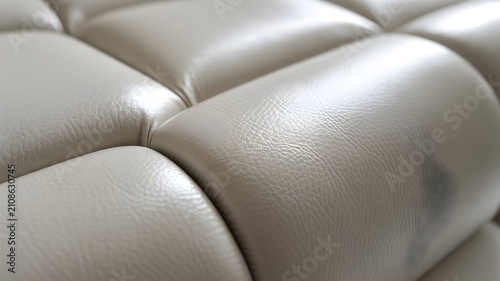 Closeup of luxurious beige leather upholstery with tufted pattern and visible grain texture, high quality furniture material