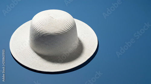 Textured White Sun Hat Displayed On A Solid Blue Background Studio Shot