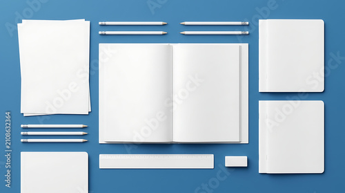 Top Down View Of Open Notebook With Pencils Ruler And Eraser On Blue Background