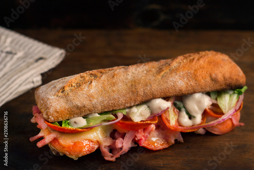 Cuadro en lienzo Gourmet ciabatta sandwich with pepperoni, ham and lettuce.
