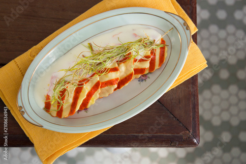 фотографія Gourmet plate of homemade bicolor ravioli pasta on a rustic table