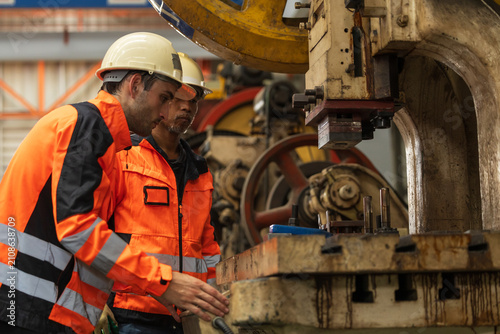 Bild auf Leinwand Male manufacturing in high visibility jacket and hard hat operator managing machine