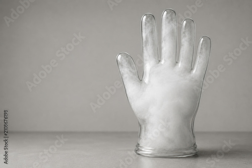 Transparent glove is filled with dense white mist. Space for text.