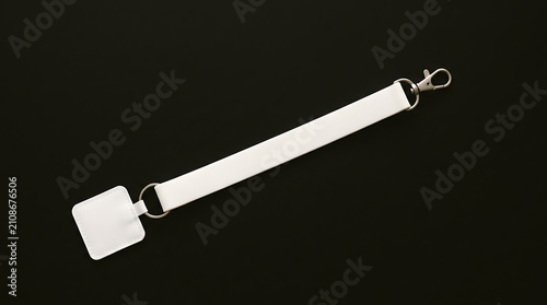 White Phone Lanyard With Metal Clasp Isolated on Black Background for Easy Carrying and Access to Devices