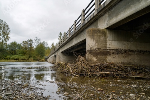 Natural Flood Debris Accumulated Against Urban Bridge Pier After Flash Flood Illustrating Climate Related Extreme Weather