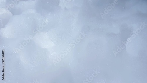 Close-up of fluffy white foam stirring and bending in a gust of wind at a foam party. Foam Party Concept, Entertainment, Summer Vacation. High quality 4k footage