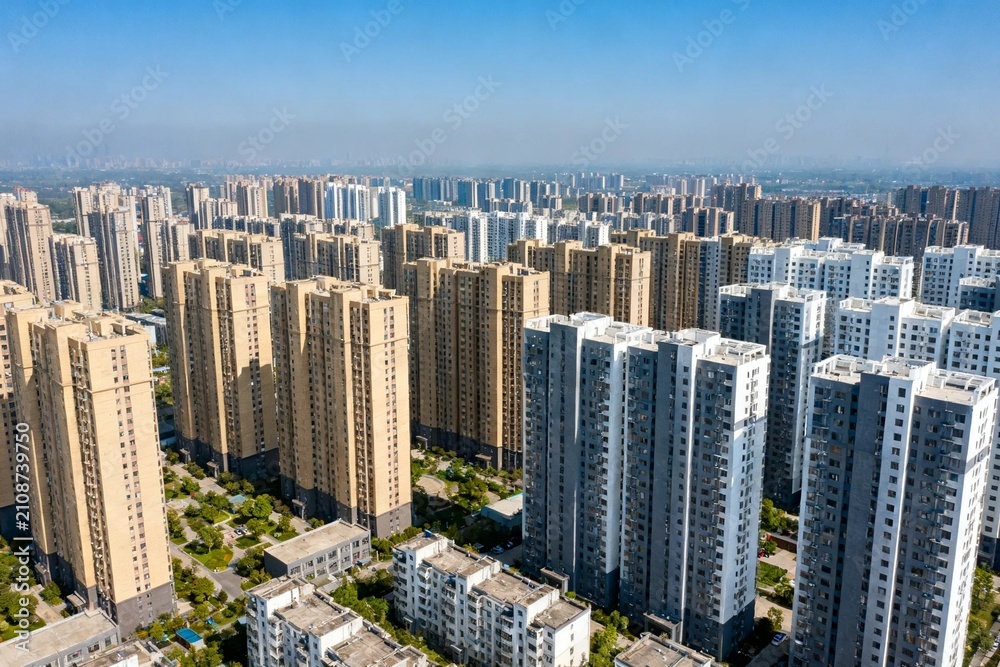 Obraz premium Dense Urban Apartment Skyline Under Clear Blue Sky