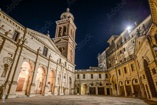 Obraz na płótnie Piazza Santa Barbara with basilica portico and bell tower illuminated at night,