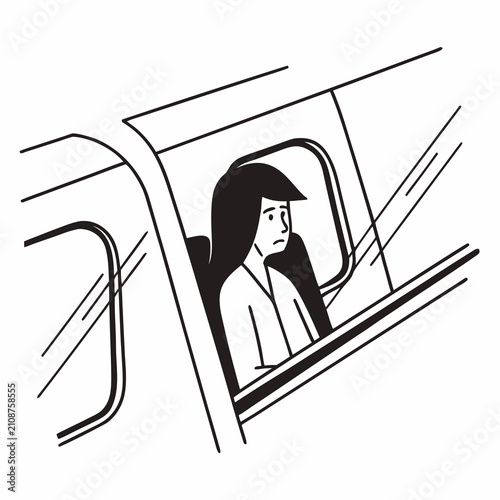 Woman sitting alone in train carriage looking out of window  