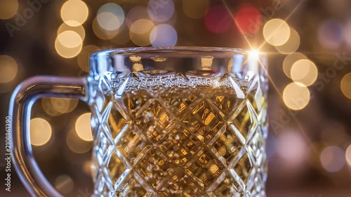 Purple-lit textured glass mug with a diamond pattern and soft warm bokeh lights in the background