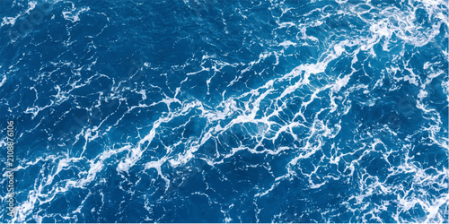 Фотография Deep blue ocean water with white foam creating abstract patterns from above, highlighting the dynamic movement of the waves