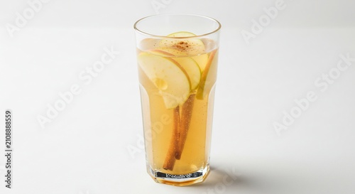 Spiced Apple Drink: A refreshing glass of spiced apple drink, infused with cinnamon sticks and apple slices, perfect for a cozy autumn day.