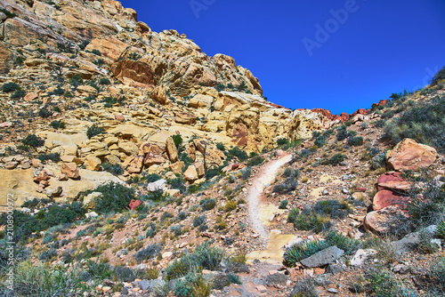 Photography Desert Trail Through Rocky Sandstone Formations and Blue Sky in Nevada