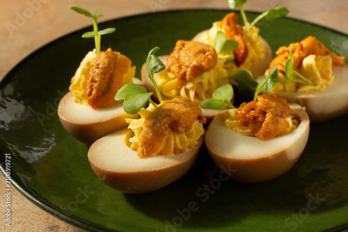 Konstfotografi A closeup view of a plate of uni deviled eggs.