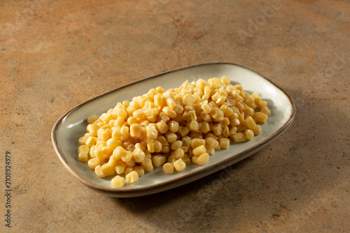 A view of a plate of canned white corn.