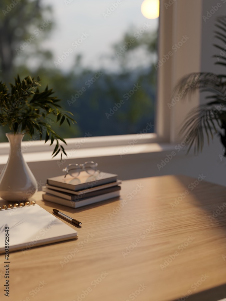 Obraz premium Cozy workspace desk with notebook pen glasses and plant vase near window