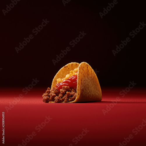 Delicious Taco with Ground Meat and Ketchup on Red Background