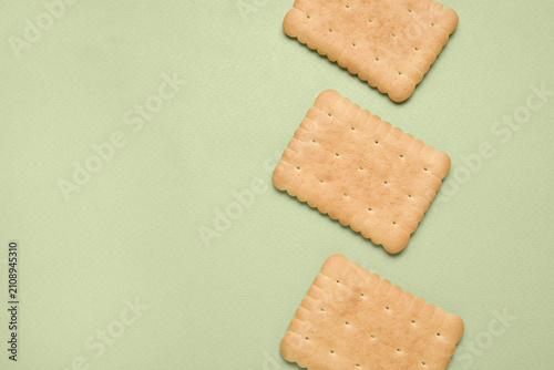 Tasty biscuits on green bac...