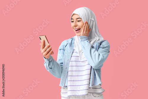 Surprised young Muslim woma...