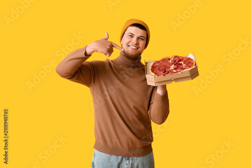 Young man pointing at cardb...