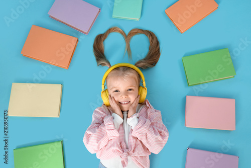 Cute little girl in headpho...