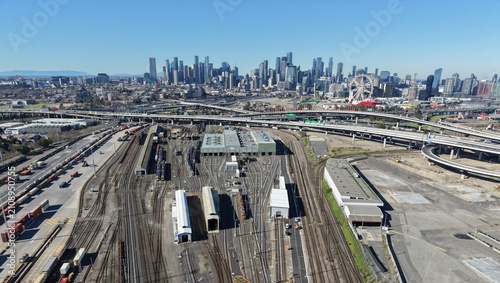 Melbourne city skyline rising over industrial railyard infrastructure
