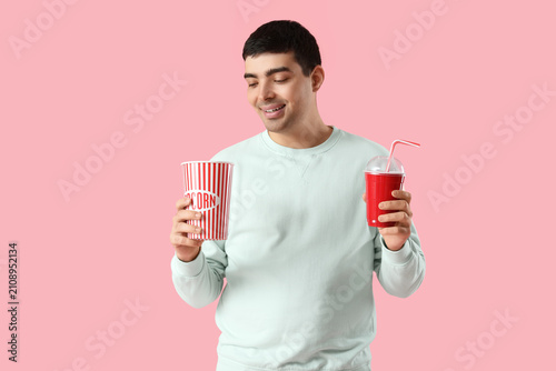 Happy young man with popcor...