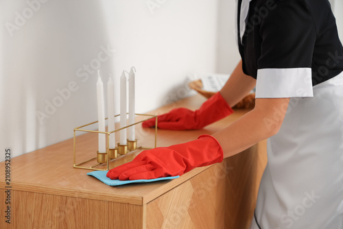 Chambermaid cleaning wooden...