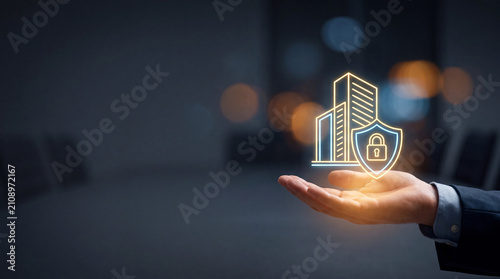 Businessman holding digital building security icon. Corporate property protection concept.
