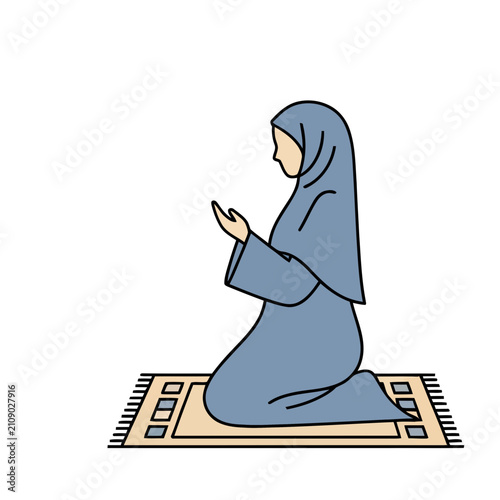 Woman in hijab praying on a rug