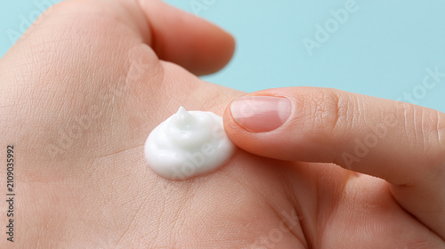White creamy lotion applied to hand showing smooth texture and skin care product for beauty.