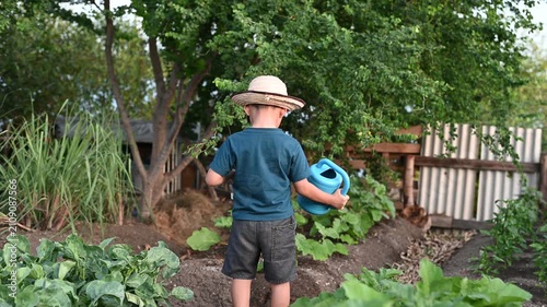 4 Year Old ASEAN Boy Planting Young Vegetable Seedlings in Soil Learning Organic Gardening and Sustainable Food Production