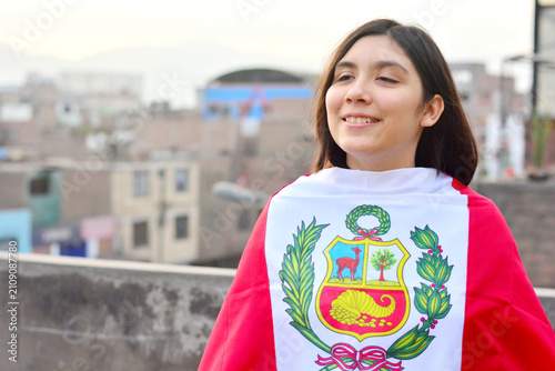 Teenager girl wrapped in peruvian flag.