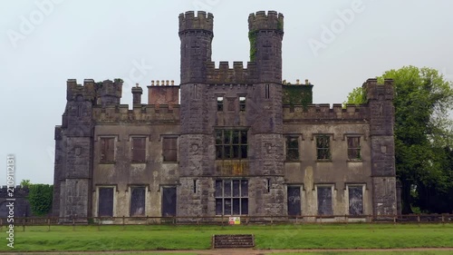 Symmetrical low aerial dolly approaching Castle Saunderson revealing architectural grandeur and fortress stonework, Cavan Ireland