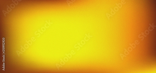 Фотография Abstract yellow and orange textured background with a soft light vignette effect