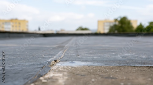 Water blister beneath roof insulation: damaged coating