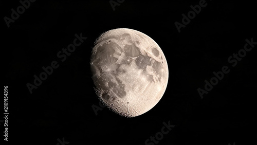 Detailed view of the Moon's surface showing craters and texture against a black sky