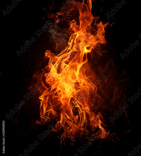 Fotografie Captivating inferno with vibrant orange flames swirling upwards against isolated black background capturing element of fire energy and intense motion