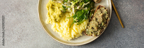 Canvas Print Boiled potatoes are served with hummus alongside a gluten free sandwich filled w