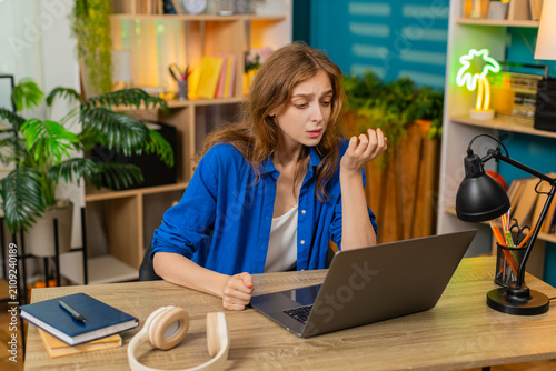Cuadro en lienzo Young woman on home table sees laptop error feels upset after online rejection with sad sigh in living room