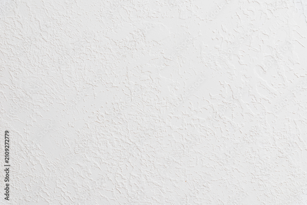 Fototapeta premium White textured plaster wall background with copy space. Minimalist white stucco surface banner featuring a rough structural pattern.
