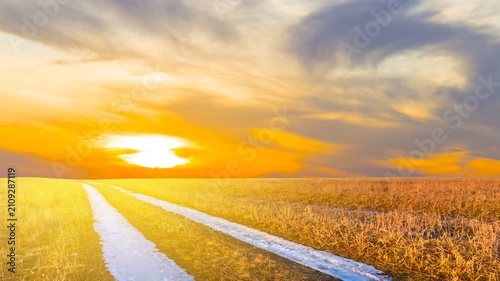 frozen rural road to a sunset time lapse scene