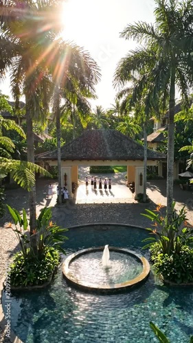 Tropical resort courtyard with a fountain and traditional welcoming ceremony