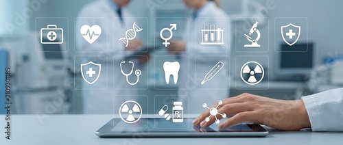 A medical professional utilizing a tablet in a clinical environment surrounded by healthcare icons that represent various aspects of medical technology and patient care.