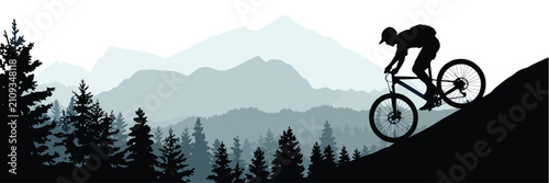 Konstfotografi Extreme cyclist silhouette mountain biking downhill in wild forest landscape with distant peaks and pine trees for travel and active lifestyle advertisement or sports promotion