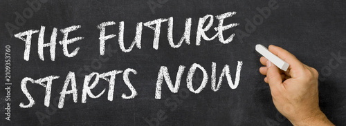 Text written on a blackboard - The Future Starts Now