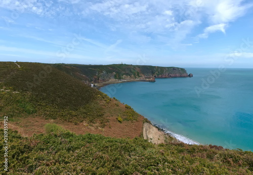 scenic panorama of lush green coastline overlooking the turquoise ocean